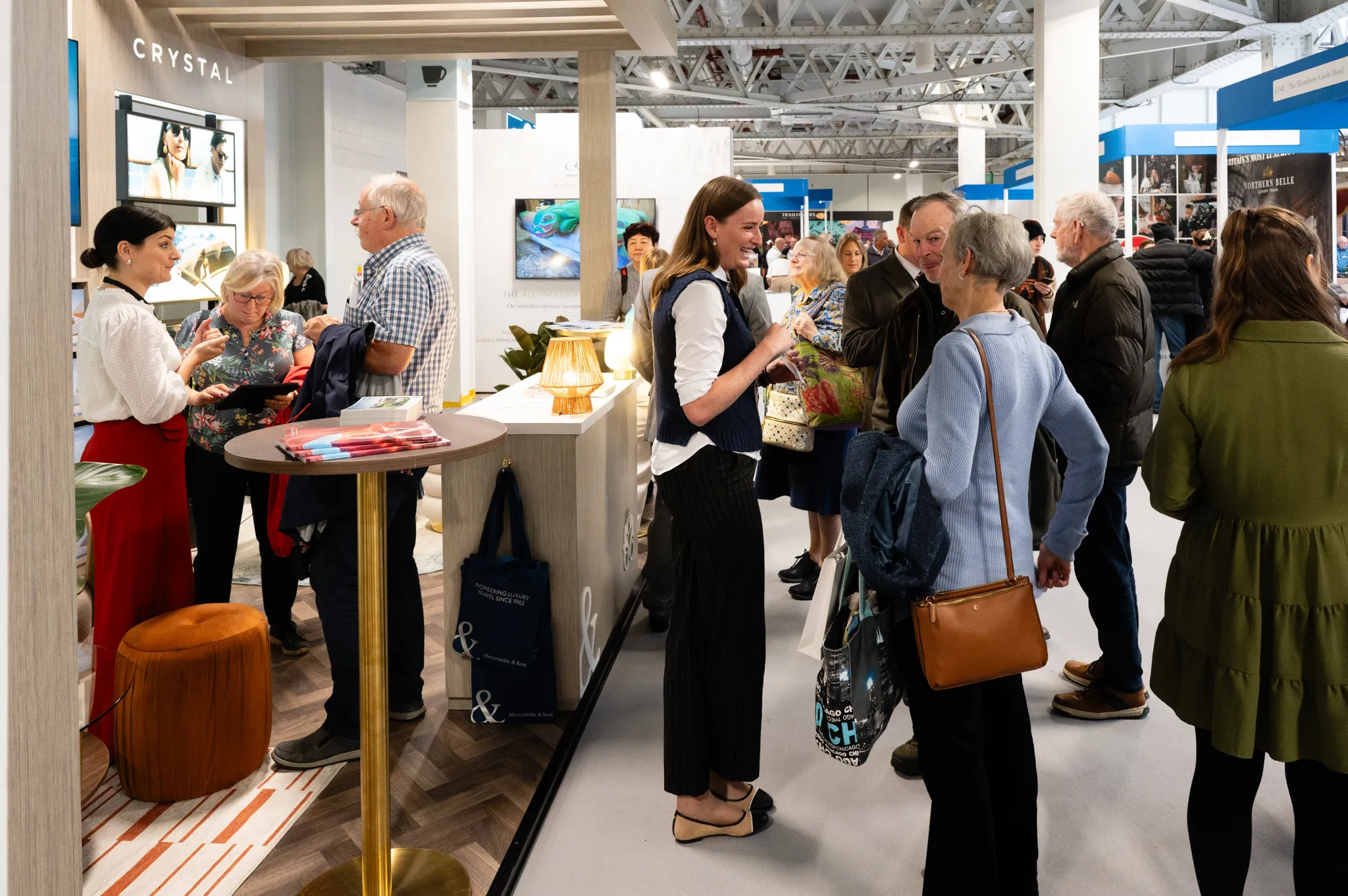 A group of people exploring exhibitor stands.